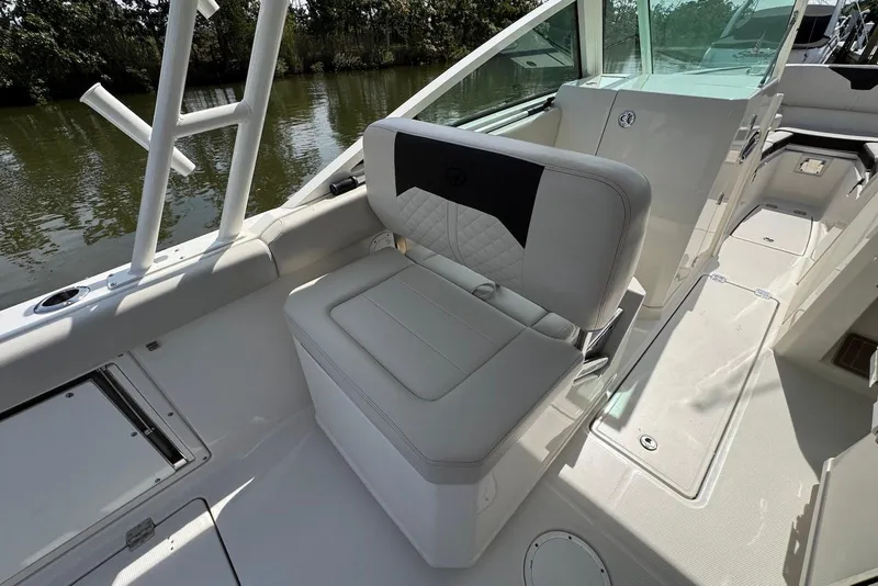 Slide: The Image of 2022 Sailfish 276 DC boat interior with white seating and sleek design. - 11
