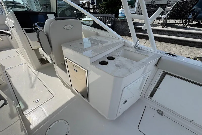Slide: The Image of 2022 Sailfish 276 DC boat interior with seating, sink, and storage compartments. - 12