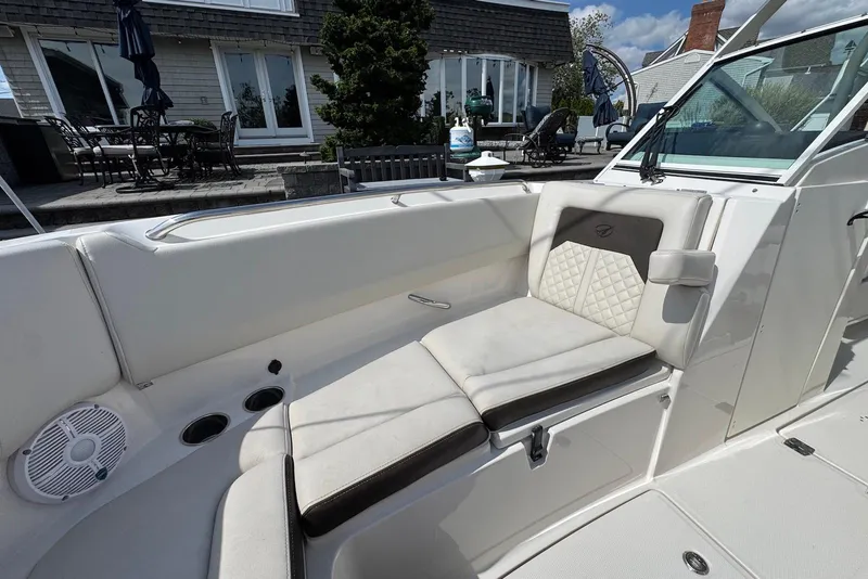Slide: The Image of 2022 Sailfish 276 DC boat interior with cushioned seating and modern design. - 22