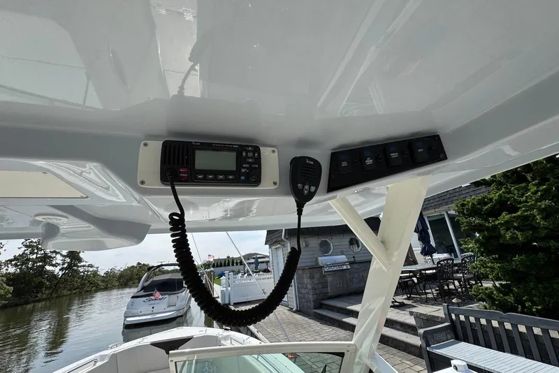 Slide: The Image of 2022 Sailfish 276 DC boat dashboard with radio and control panel. - 25