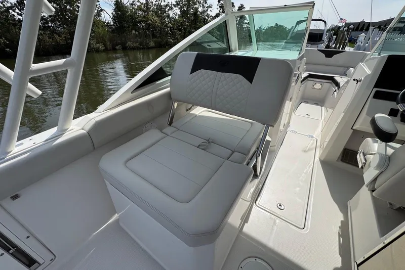 Slide: The Image of 2022 Sailfish 276 DC boat interior with cushioned seating and sleek design. - 26