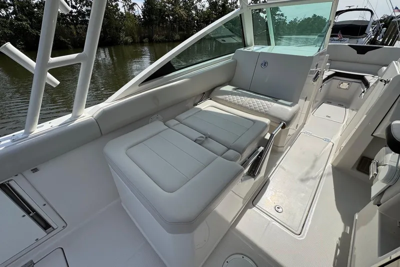 Slide: The Image of 2022 Sailfish 276 DC boat interior with white seating and sleek design. - 28
