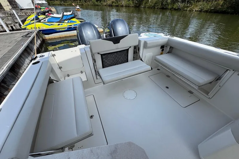 Slide: The Image of 2022 Sailfish 276 DC boat interior with seating, docked by water. - 30