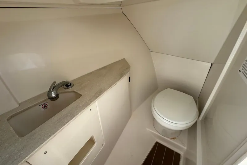Slide: The Image of 2022 Sailfish 276 DC boat bathroom with sink and toilet. - 33