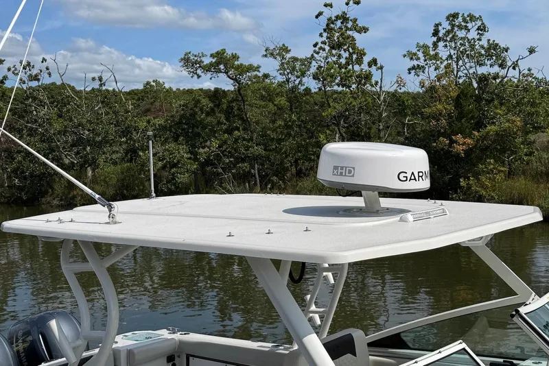 Slide: The Image of 2022 Sailfish 276 DC boat with Garmin radar on top, surrounded by lush greenery. - 5
