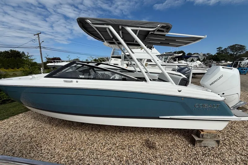 The Image of 2025 Cobalt R4 Outboard boat with Mercury engine, parked on gravel under a blue sky. - 0