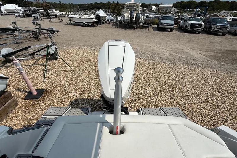 Slide: The Image of 2025 Cobalt R4 Outboard boat in a gravel lot with trailers and vehicles. - 18