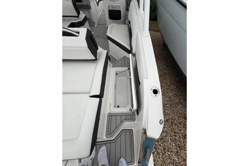Slide: The Image of 2025 Cobalt R4 Outboard boat interior with white seating and sleek design. - 25
