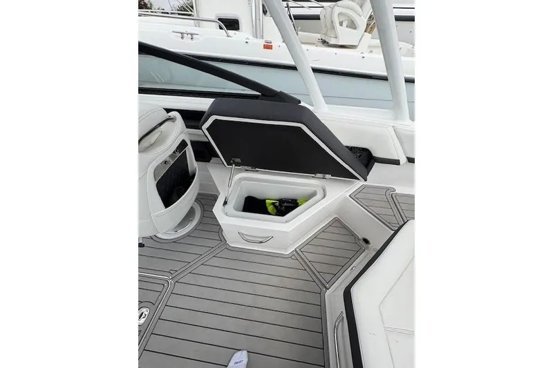 Slide: The Image of 2025 Cobalt R4 Outboard boat interior with open storage compartment on deck. - 27