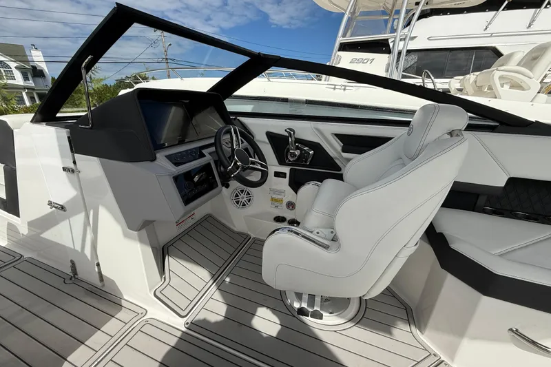 Slide: The Image of 2025 Cobalt R4 Outboard boat interior with modern helm and white captain's chair. - 29