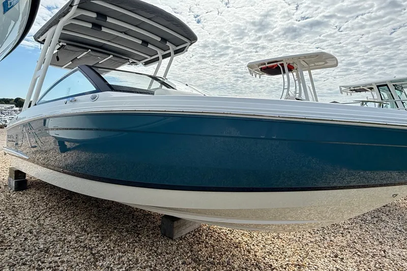 Slide: The Image of 2025 Cobalt R4 Outboard boat on gravel, under cloudy sky. - 3