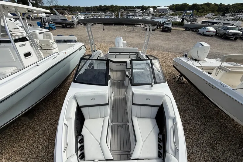 Slide: The Image of 2025 Cobalt R4 Outboard boat with sleek design, docked among other boats. - 38