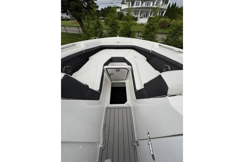 Slide: The Image of 2025 Cobalt R4 Outboard boat interior with white seating and gray flooring. - 40