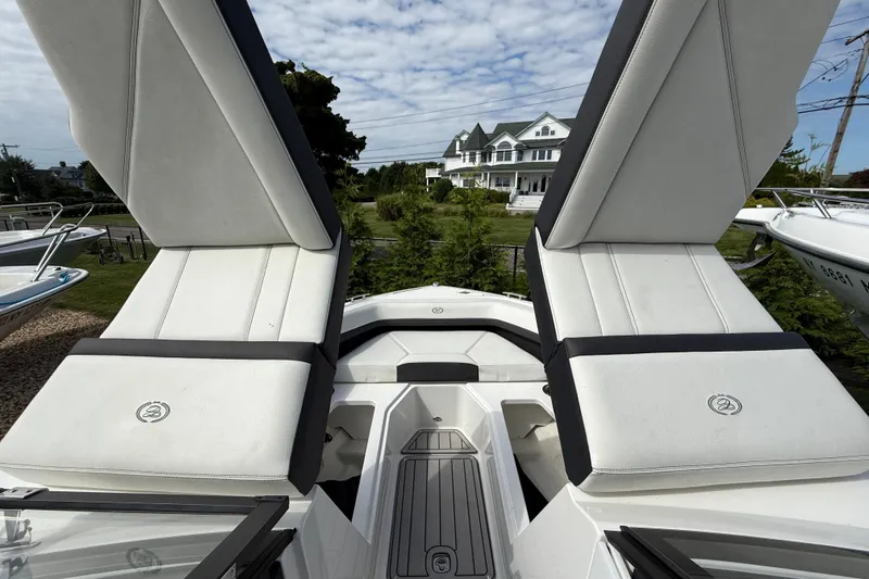 Slide: The Image of 2025 Cobalt R4 Outboard boat with luxurious white seating and scenic background. - 42