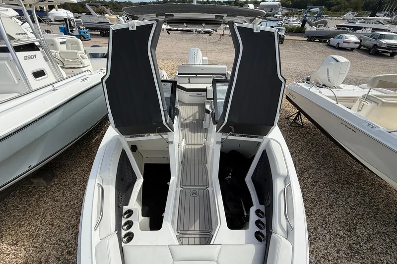 Slide: The Image of 2025 Cobalt R4 Outboard boat with open storage compartments, docked among other boats. - 43