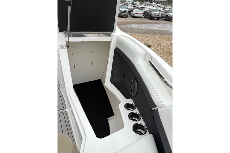 Slide: The Image of 2025 Cobalt R4 Outboard boat interior with storage compartment and cup holders. - 44