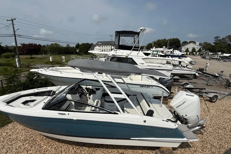 Slide: The Image of 2025 Cobalt R4 Outboard boat displayed in a marina with other vessels. - 49
