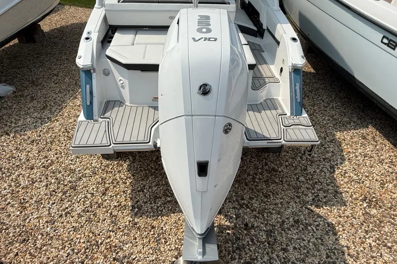 Slide: The Image of 2025 Cobalt R4 Outboard boat with powerful engine, displayed on gravel surface. - 5