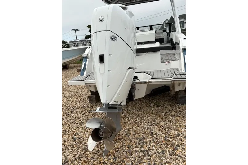 Slide: The Image of 2025 Cobalt R4 Outboard boat with powerful engine on gravel surface. - 6