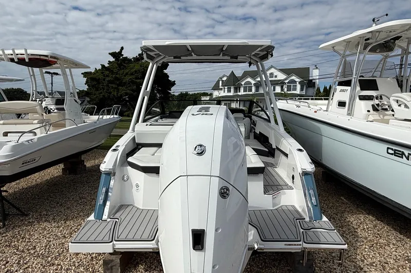 Slide: The Image of 2025 Cobalt R4 Outboard boat displayed outdoors, surrounded by other boats. - 8