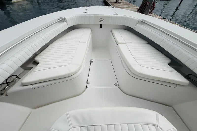 Slide: The Image of 2009 Southport 26 Center Console boat with white cushioned seating and sleek design. - 10