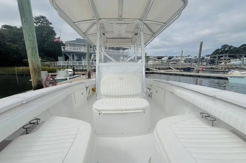 Slide: The Image of 2009 Southport 26 Center Console boat docked at marina, featuring spacious seating and sleek design. - 11