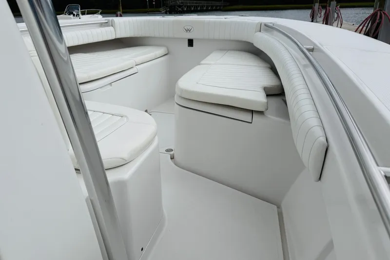 Slide: The Image of 2009 Southport 26 Center Console boat interior with white cushioned seating. - 12