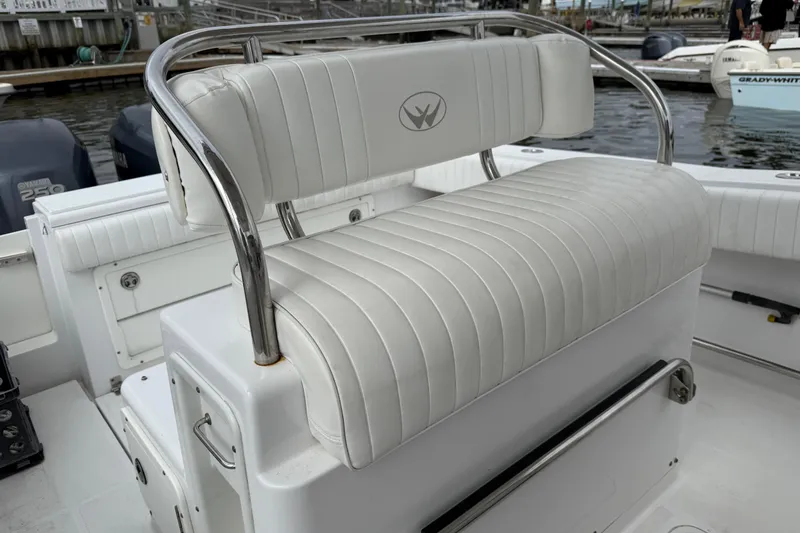 Slide: The Image of 2009 Southport 26 Center Console boat with white cushioned seating and chrome accents. - 13