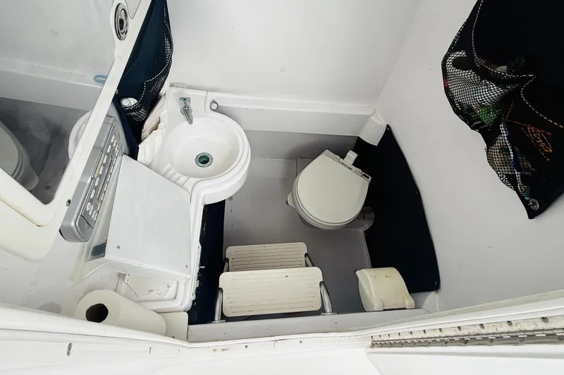 Slide: The Image of Compact bathroom in 2009 Southport 26 Center Console boat with sink and toilet. - 15