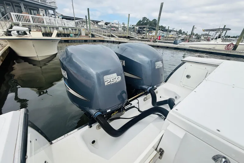 Slide: The Image of 2009 Southport 26 Center Console with twin Yamaha 250 engines docked at marina. - 16