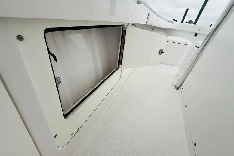 Slide: The Image of Open storage compartment on 2009 Southport 26 Center Console boat deck. - 17