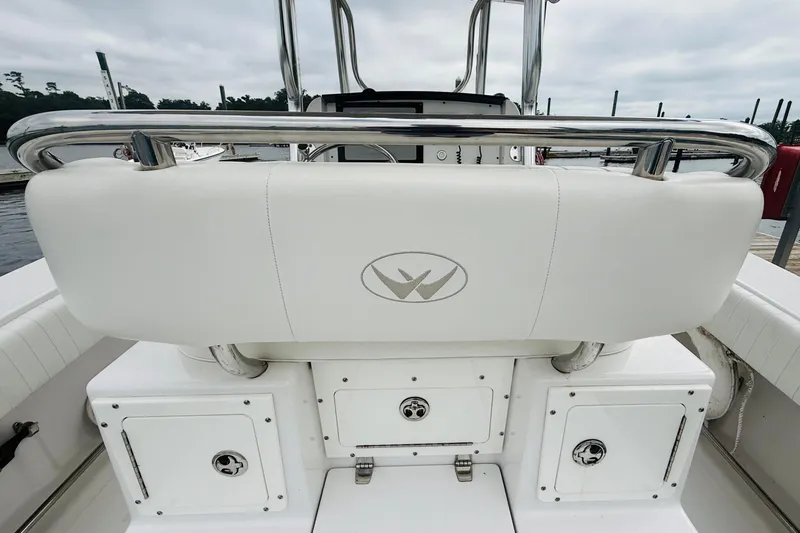 Slide: The Image of 2009 Southport 26 Center Console boat interior with white seating and storage compartments. - 18