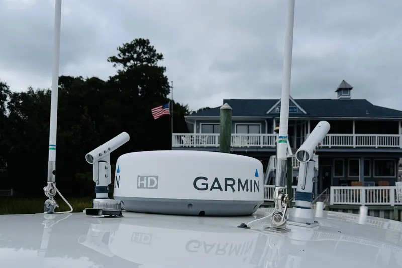 Slide: The Image of Garmin radar on 2009 Southport 26 Center Console boat, with American flag and house in background. - 19