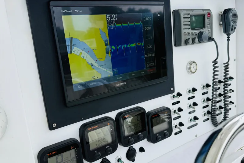 Slide: The Image of 2009 Southport 26 Center Console dashboard with GPS, gauges, and controls. - 9