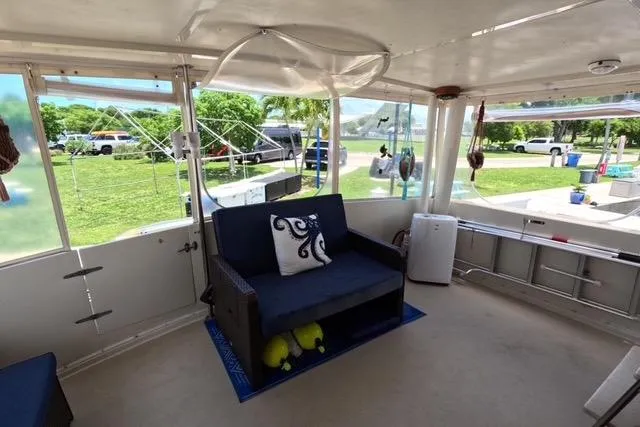 Slide: The Image of Interior of 1987 Californian 45 Motor Yacht with seating and outdoor view. - 13