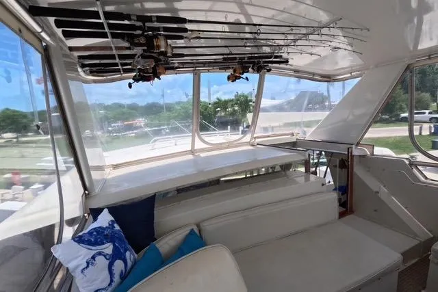 Slide: The Image of 1987 Californian 45 Motor Yacht interior with fishing rods and seating area. - 18
