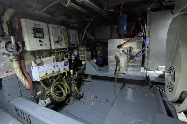 Slide: The Image of Engine room of a 1987 Californian 45 Motor Yacht with control panels and wiring. - 23