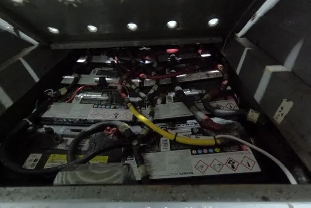 Slide: The Image of Battery compartment of a 1987 Californian 45 Motor Yacht, showing multiple connected batteries. - 24