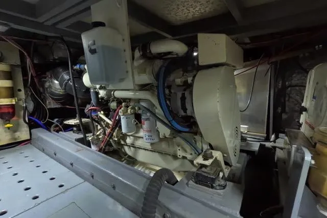 Slide: The Image of Engine room of 1987 Californian 45 Motor Yacht, showcasing mechanical components and wiring. - 27