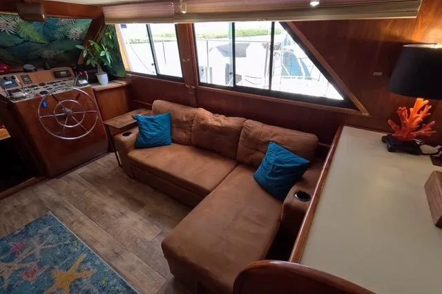 Slide: The Image of 1987 Californian 45 Motor Yacht interior with cozy seating, nautical decor, and helm station. - 33