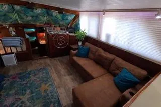 Slide: The Image of 1987 Californian 45 Motor Yacht interior with cozy seating, nautical decor, and vibrant accents. - 34