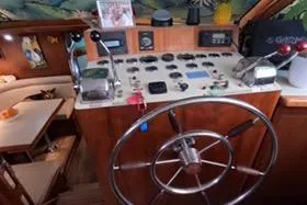 Slide: The Image of 1987 Californian 45 Motor Yacht helm with steering wheel and control panel. - 36