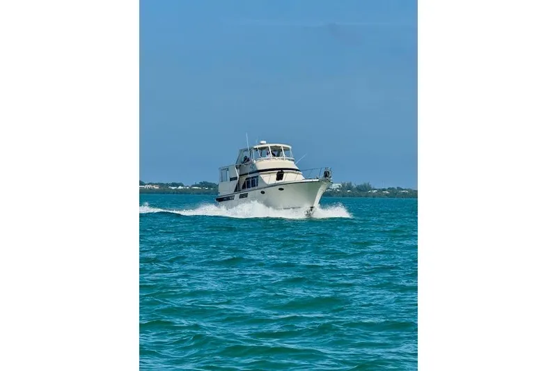 Slide: The Image of 1987 Californian 45 Motor Yacht cruising on blue ocean waters. - 4