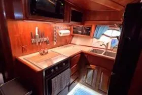 Slide: The Image of 1987 Californian 45 Motor Yacht kitchen with wooden cabinetry and modern appliances. - 41