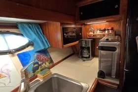 Slide: The Image of 1987 Californian 45 Motor Yacht kitchen with sink, coffee maker, and nautical decor. - 42