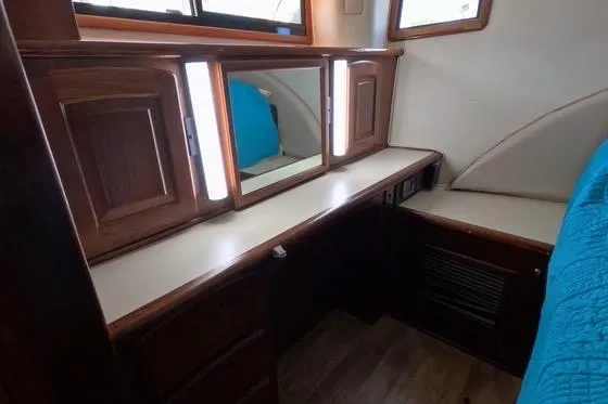 Slide: The Image of 1987 Californian 45 Motor Yacht interior with wooden cabinetry and mirrors. - 49