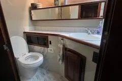 Slide: The Image of 1987 Californian 45 Motor Yacht bathroom with wooden cabinets and modern fixtures. - 60