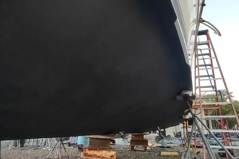 Slide: The Image of 1987 Californian 45 Motor Yacht hull in dry dock with ladder and supports. - 66