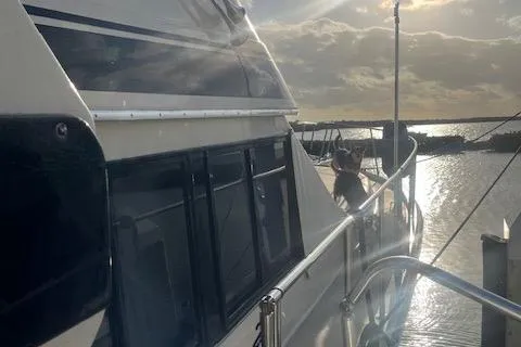 Slide: The Image of 1987 Californian 45 Motor Yacht docked at sunset with scenic water view. - 7