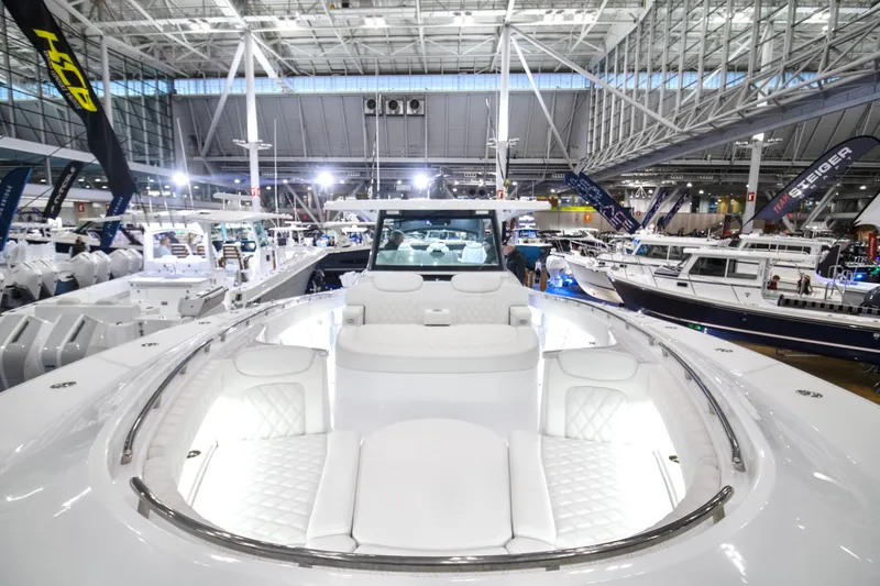 Slide: The Image of 2026 HCB 48 Campeon luxury boat displayed at an indoor boat show. - 0